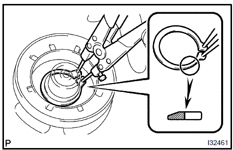 d. Using a snap ring expander, install the magnet clutch rotor