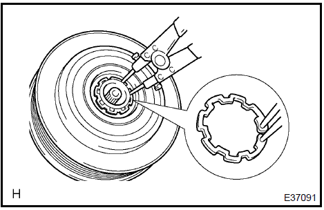 g. Using a snap ring expander, remove the snap ring and