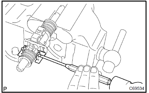 d. Using 2 screwdrivers and a hammer, remove the select