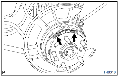 Remove parking brake shoe return tension spring