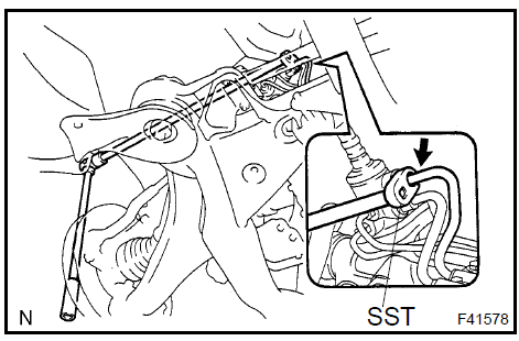 b. Using SST, disconnect the pressure feed tube assy from