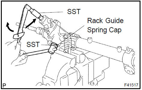 i. Using SST, hold the rack guide spring cap and using