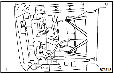 b. Using a scraper, disengage the 3 claws and remove the