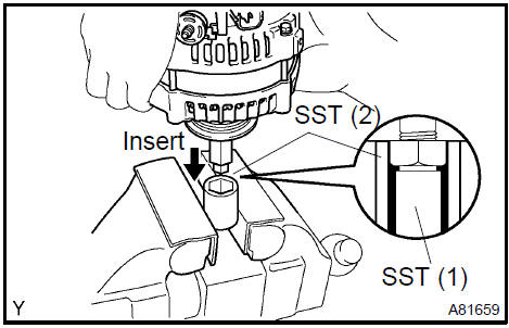 d. To loosen the pulley nut, turn SST (1−A) in the direction