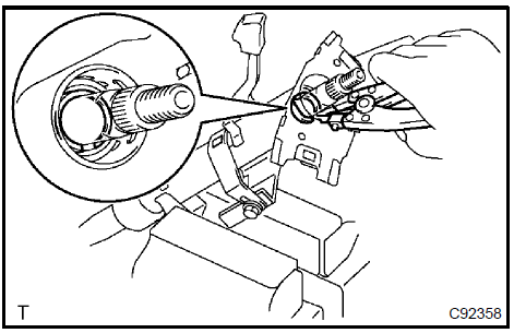 b. Using a brass bar and a hammer, remove the steering
