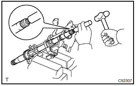 c. Using a snap ring expander, remove the steering main