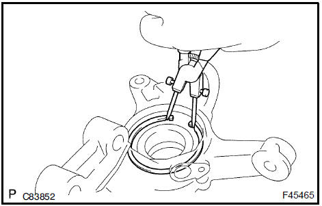 Remove front axle hub LH hole snap ring