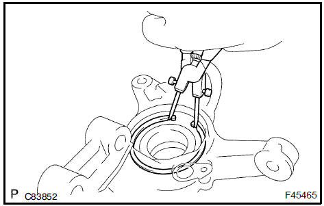 Install front axle hub LH hole snap ring