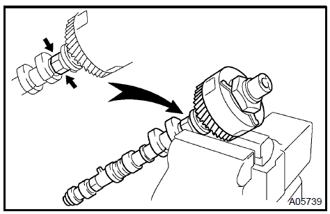 b. Using a 46 mm socket wrench, remove the lock nut by