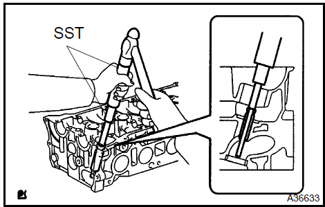 a) Using SST and a hammer, tap in a new guide bush to the