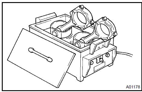 b. Using a plastic−faced hammer and brass bar, lightly tap