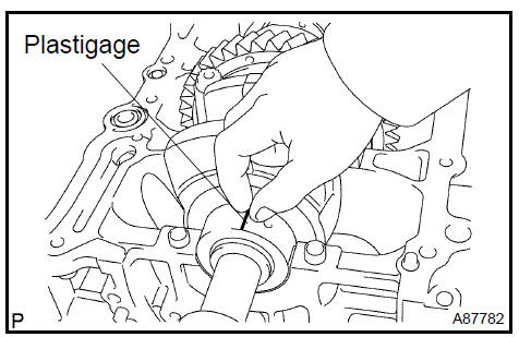 j. Measure the Plastigage at its widest point.