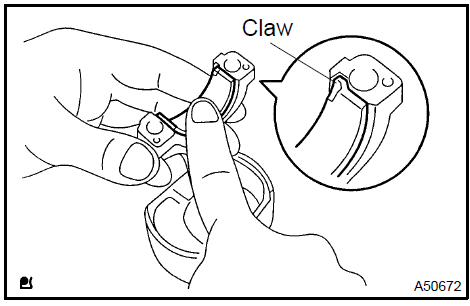 c. Using a piston ring compressor, push the correctly numbered