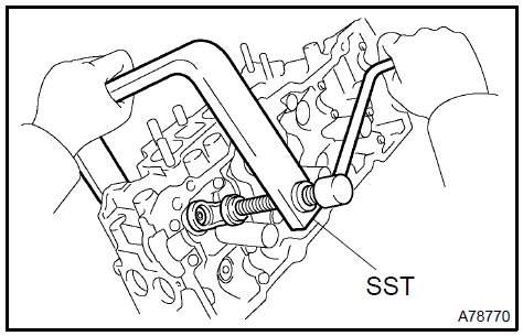 c. Using a plastic−faced hammer and a discarded valve with