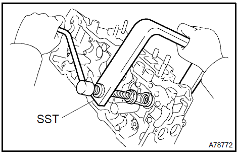 c. Using a plastic−faced hammer and a discarded valve with