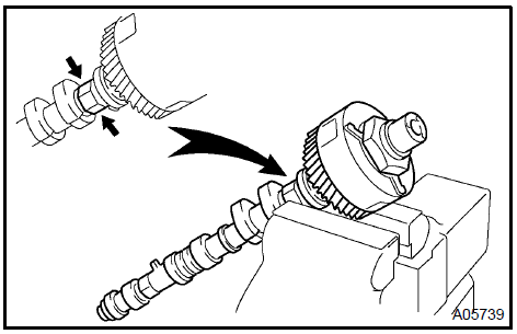 b. Using a 46 mm socket wrench, remove the lock nut by