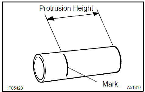 c. Using a press and wooden block, install the spark plug