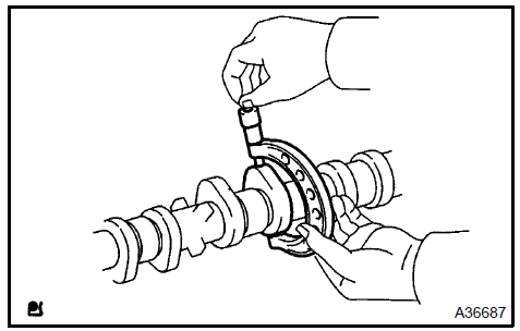 c. Using a micrometer, measure the journal diameter.